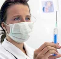 woman mesothelioma doctor holds syringe