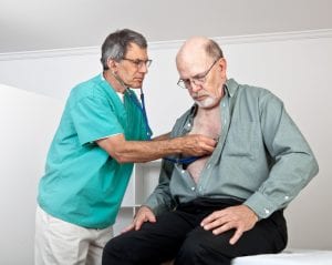 doctor listening to old mans chest for pleural mesothelioma diagnosis